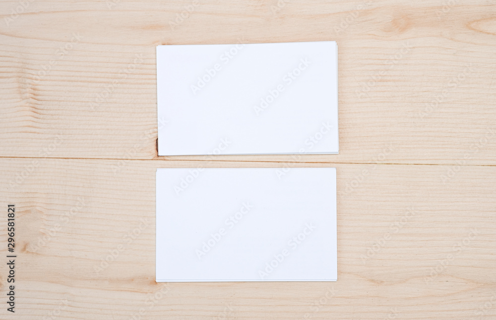 Blank template for branding identity of white business name card for mock up process on wooden table background. Blank template for branding identity of white business name card for mock up process on wooden table background.