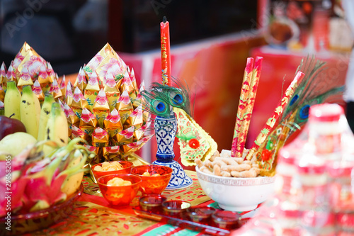 Chinese New Year Decoration. Festive food,  fresh fruits and other set up for Chinese New Year festival with soft focus on the joss paper in golden offering dish. Chinese words meaning life and water