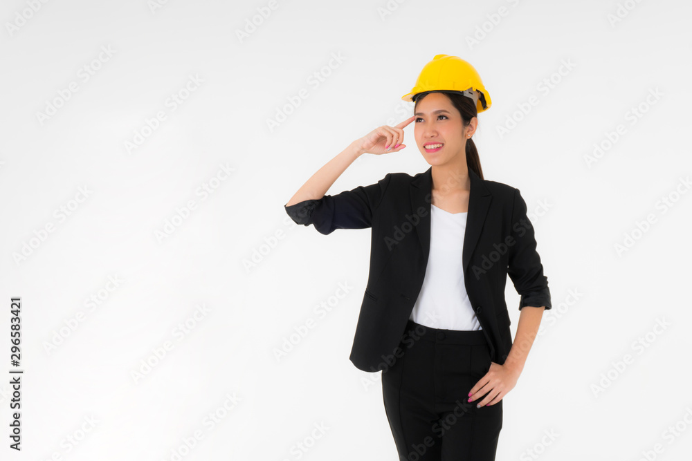 Young Female engineers with Safety helmet are getting new ideas. Or thinking about something Her index finger touches the head. She wore a black suit, standing isolated on a white background. Young Female engineers with Safety helmet are getting new ideas. Or thinking about something Her index finger touches the head. She wore a black suit, standing isolated on a white background.
