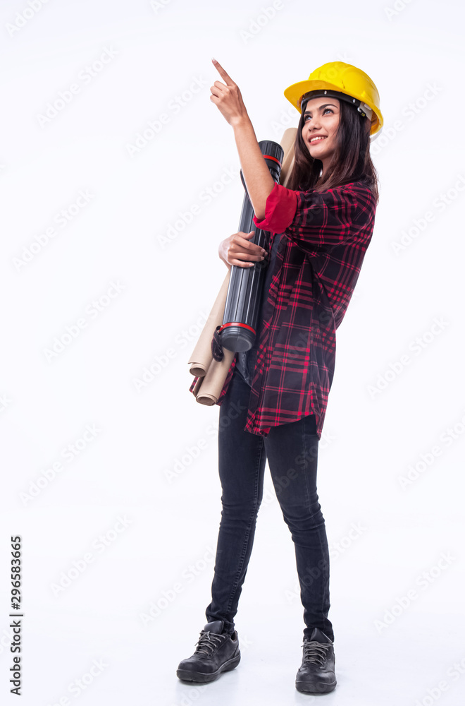 The young woman engineer with yellow safety helmet and hold blueprint in her hand,point finger up in the air,for checking something,standing on white background The young woman engineer with yellow safety helmet and hold blueprint in her hand,point finger up in the air,for checking something,standing on white background