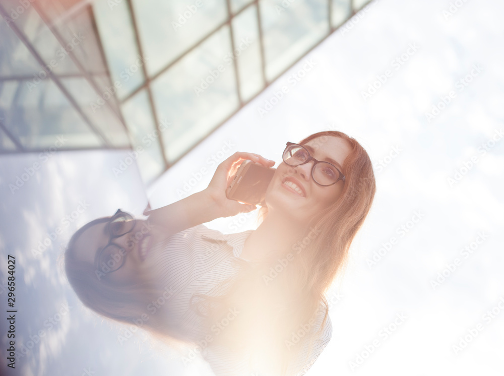 High key portrait of happy businesswoman talking on mobile phone High key portrait of happy businesswoman talking on mobile phone