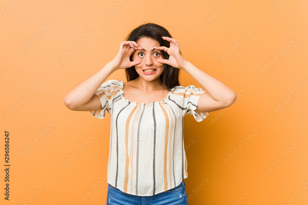 Young curvy woman keeping eyes opened to find a success opportunity. Young curvy woman keeping eyes opened to find a success opportunity.