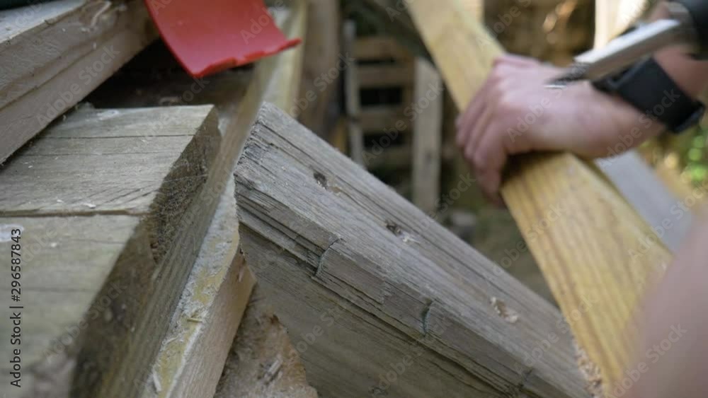 Male hand using electric screwdriver, another hand holds piece of wood. Handheld Male hand using electric screwdriver, another hand holds piece of wood. Handheld