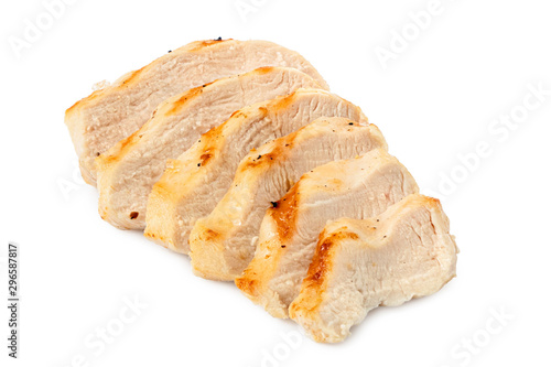 Sliced grilled chicken breast with grill marks, ground black pepper and salt isolated on white.