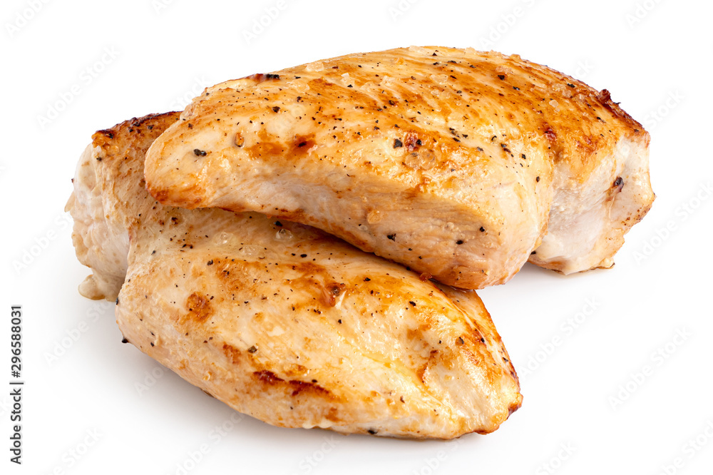 Two whole pan roasted chicken breasts isolated on white. Two whole pan roasted chicken breasts isolated on white.