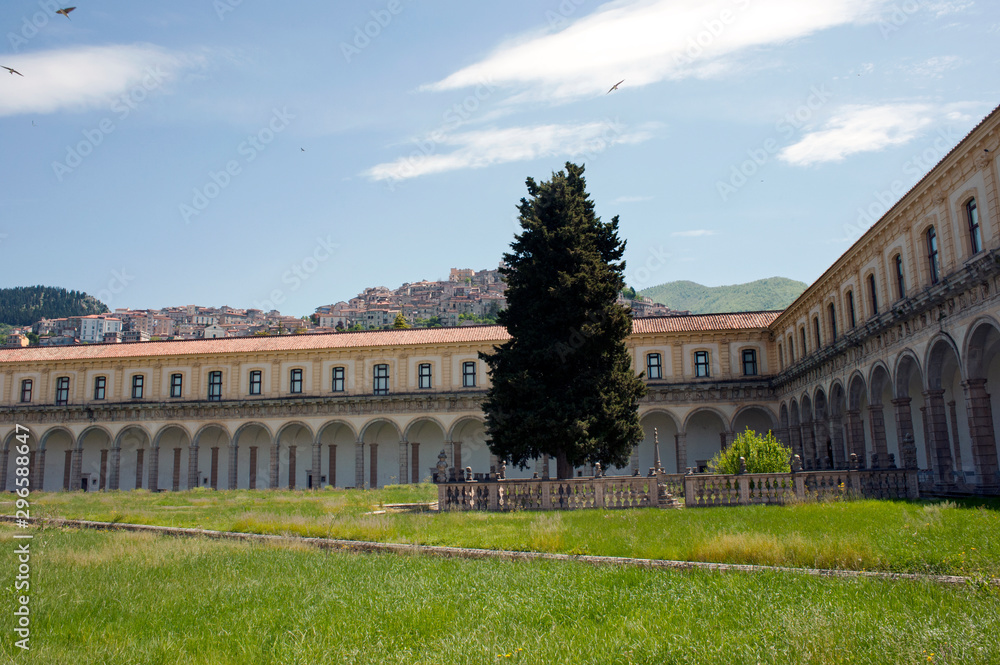 One of the cloisters of Padula Charterhouse with Padula hamlet in the background, Salerno, Italy