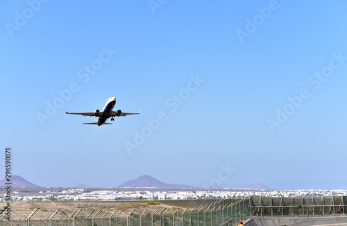 Passenger plane flying goes on takeoff in the blue sky, Lanzarote, Canary Islands, Spain