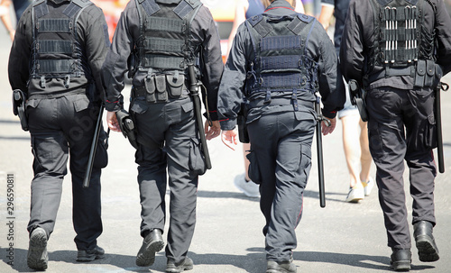 four policemen of special force unit patroling the city