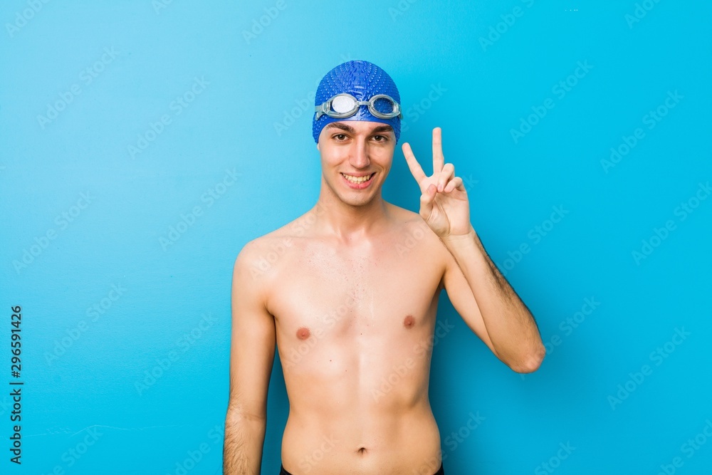 Young swimmer man showing number two with fingers.