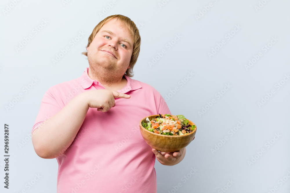 Caucasian crazy blond fat man holding a salad bowl Caucasian crazy blond fat man holding a salad bowl