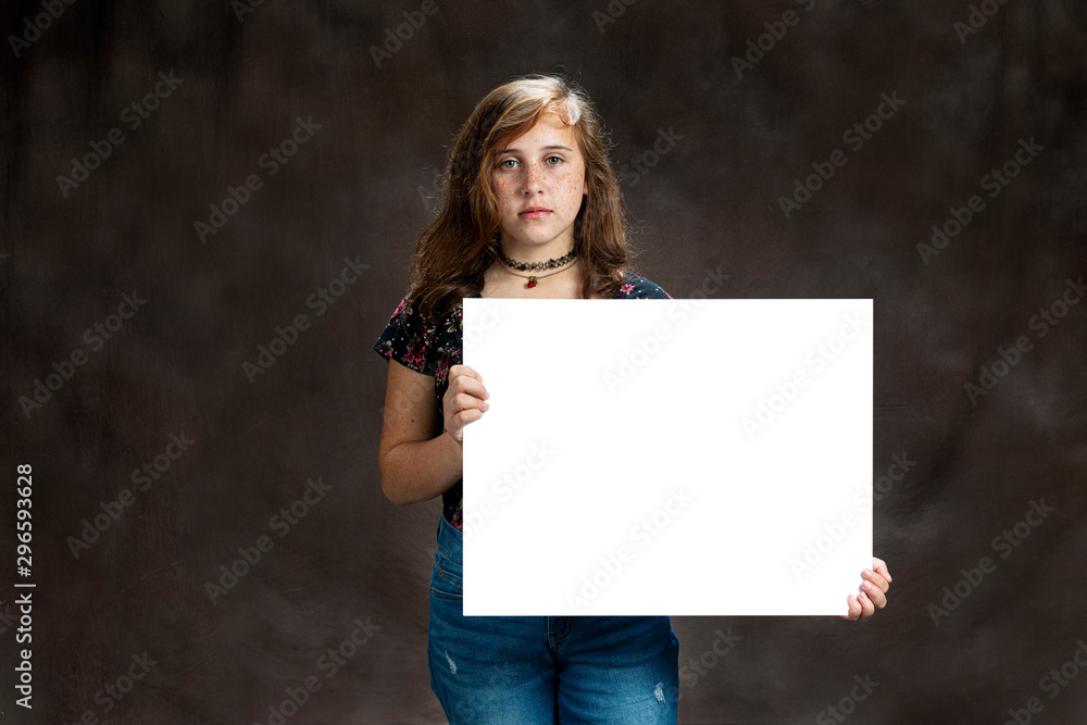 Serious Looking Pre-Teen Girl With Freckles Holding Blank Sign Serious Looking Pre-Teen Girl With Freckles Holding Blank Sign
