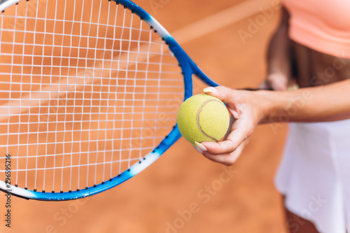 Female athlete hits a tennis ball with a racket © speed300