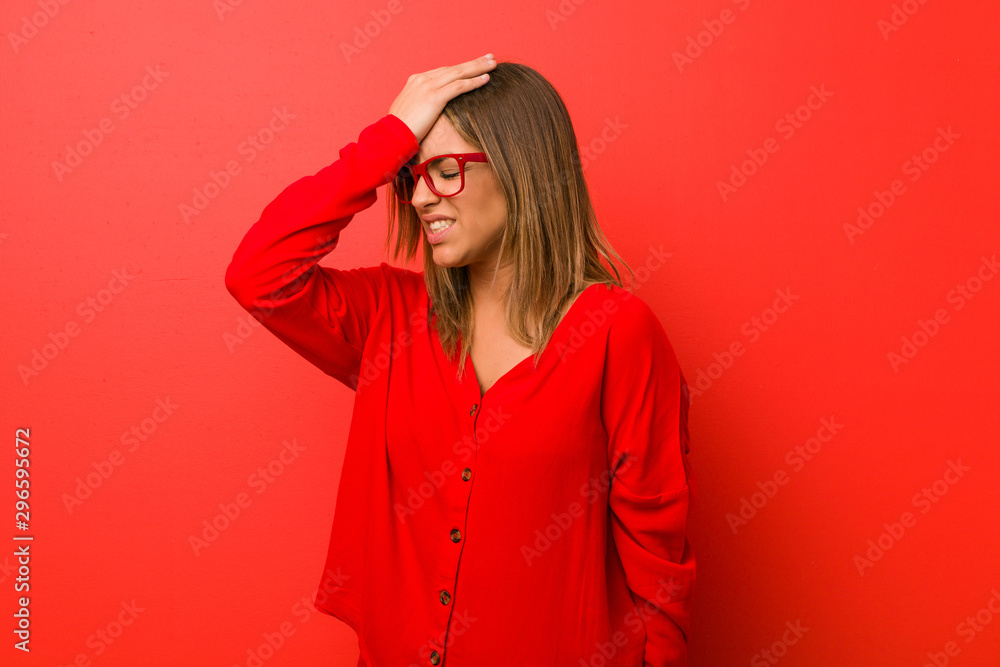 Young authentic charismatic real people woman against a wall forgetting something, slapping forehead with palm and closing eyes. Young authentic charismatic real people woman against a wall forgetting something, slapping forehead with palm and closing eyes.