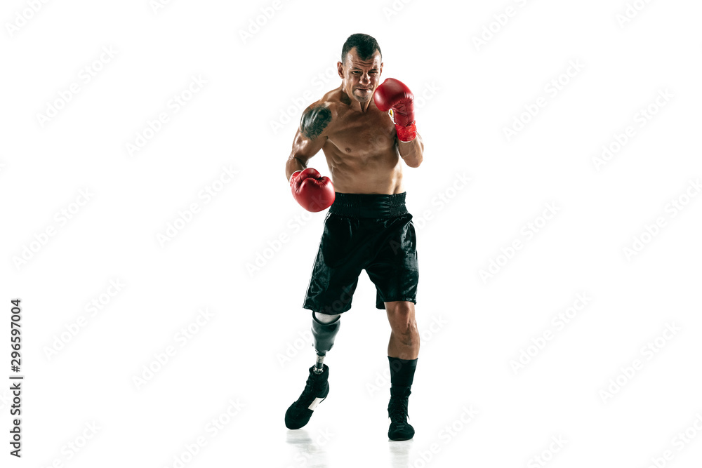 Full length portrait of muscular sportsman with prosthetic leg, copy space. Male boxer in red gloves. Isolated shot on white studio background.