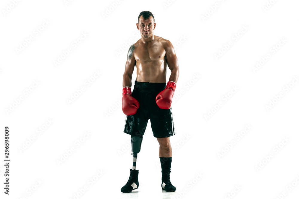 Full length portrait of muscular sportsman with prosthetic leg, copy space. Male boxer in red gloves. Isolated shot on white studio background. Full length portrait of muscular sportsman with prosthetic leg, copy space. Male boxer in red gloves. Isolated shot on white studio background.