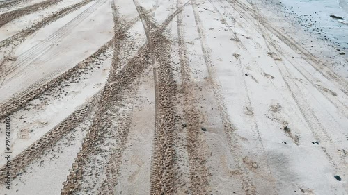 race from the car on the shore of the ocean , tire tread marks in the sand of the beach  photo