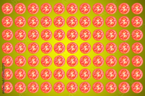 Vegetable pattern of red tomatoes sliced       on yellow background.