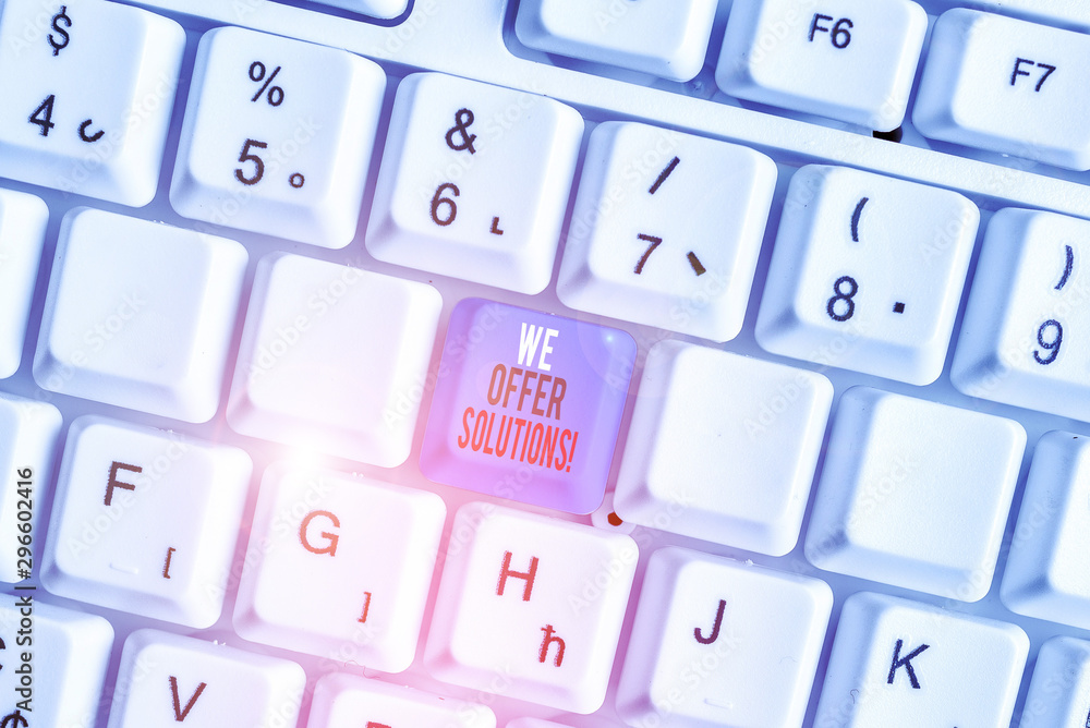 Writing note showing We Offer Solutions. Business concept for way to solve problem or deal with difficult situation White pc keyboard with note paper above the white background Writing note showing We Offer Solutions. Business concept for way to solve problem or deal with difficult situation White pc keyboard with note paper above the white background