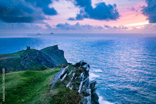 a viewpoint from bray head on valentia island in the ring of kerry in the south west coast of ireland during an autumn sunset showing the skellig islands and watchtower