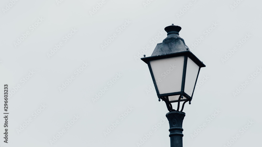 old street lamp on gray sky background