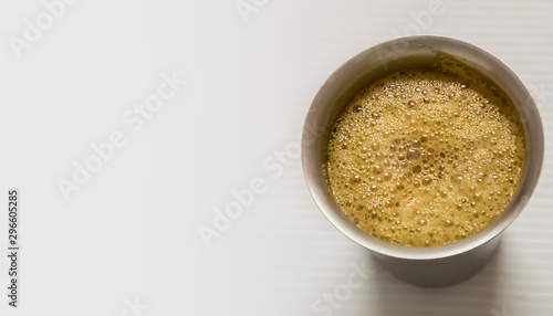 South Indian coffee served in steel glasses - white background with space for text