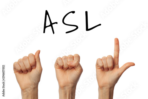 Woman showing abbreviation ASL on white background. Sign language concept photo