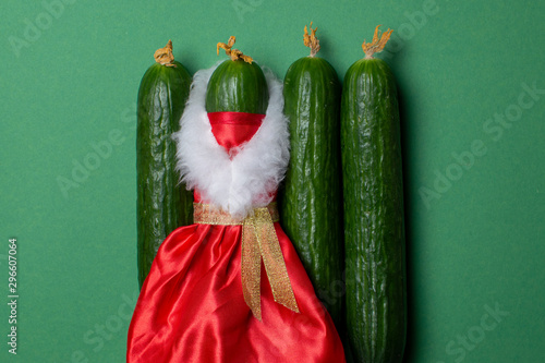 New Year cucumbers on a green background, products on the festive table, Christmas vegetables
