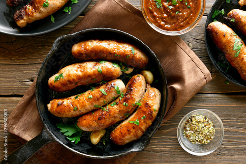 Fried sausages in frying pan photo