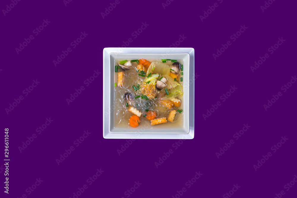 Fototapeta premium Asian Thai food on white plates with purple background with copy space