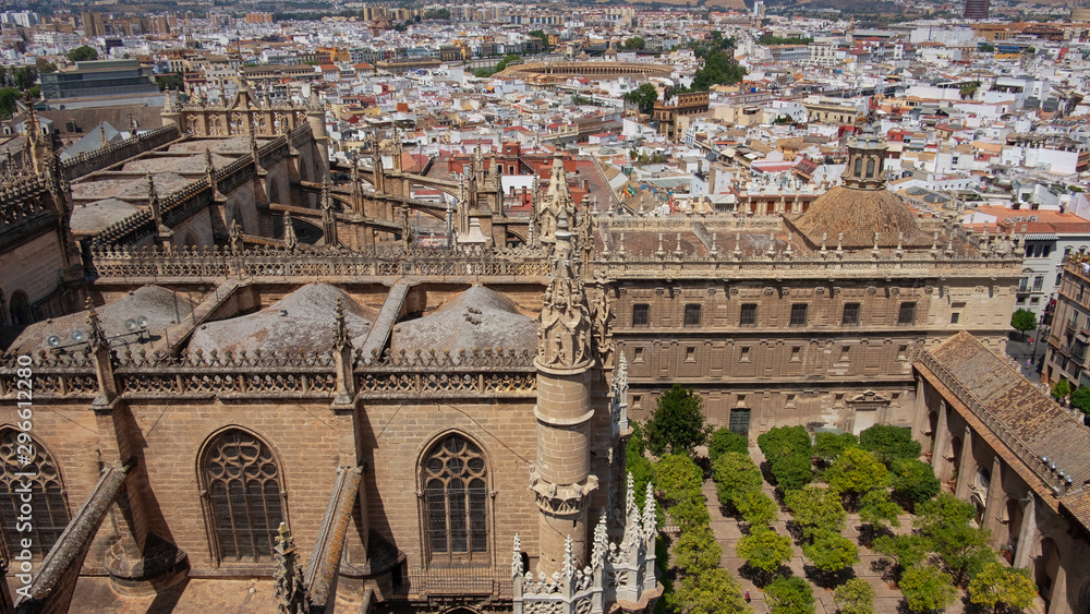 Catedral de Santa Maria de la Sede, views from the La Giralda tower, part of the  Roman Catholic cathedral in Seville, towards roofs, gardens and surrounded by the city, Seville, Spain