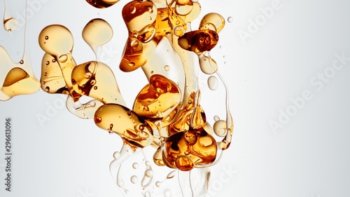 transparent orange gold oil bubbles and fluid shapes in purified water on a white gradient background. Side angle with crystal colored bubbles in purified cosmetic water backdrop with copy space for s