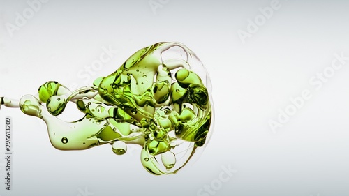 фотографія transparent green oil bubbles and fluid shapes in purified water on a white gradient background