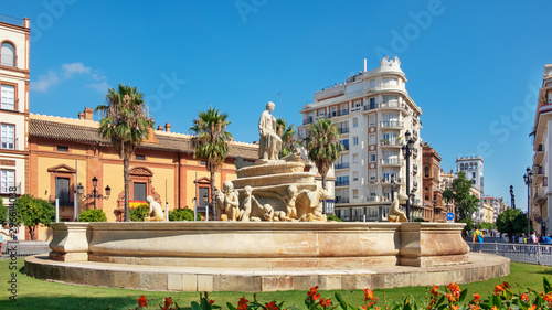 Billede på lærred Fountain of Hispalis, landmark in Puerta de Jerez, a sea nymph carried by childr