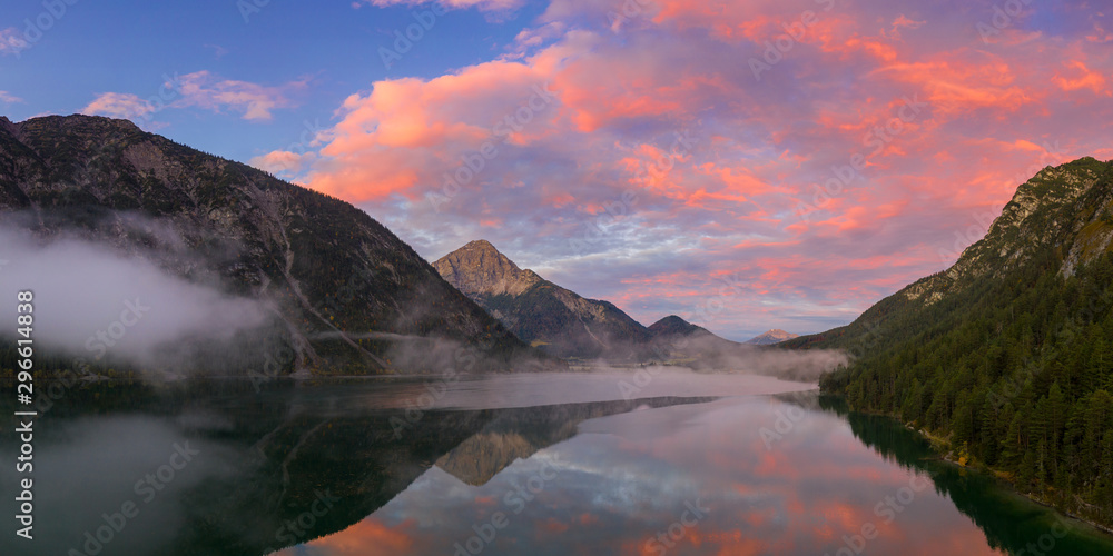 heiterwanger see lake with red sky aurora and mountains at dawn