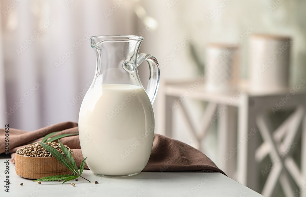 Composition with hemp milk on white table indoors Composition with hemp milk on white table indoors