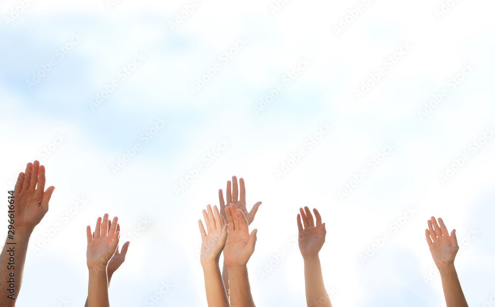 Group of volunteers raising hands outdoors, closeup Group of volunteers raising hands outdoors, closeup