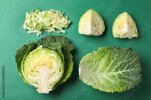 Fresh savoy cabbage on green background, flat lay Fototapeta