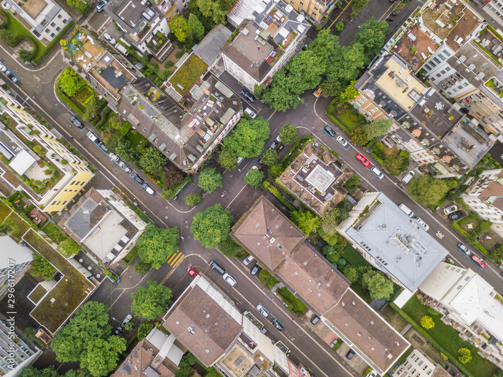 Aerial view of buildings with roofs. Streets with traffic in overhead view. Town in Europe from above.. Aerial view of buildings with roofs. Streets with traffic in overhead view. Town in Europe from above..