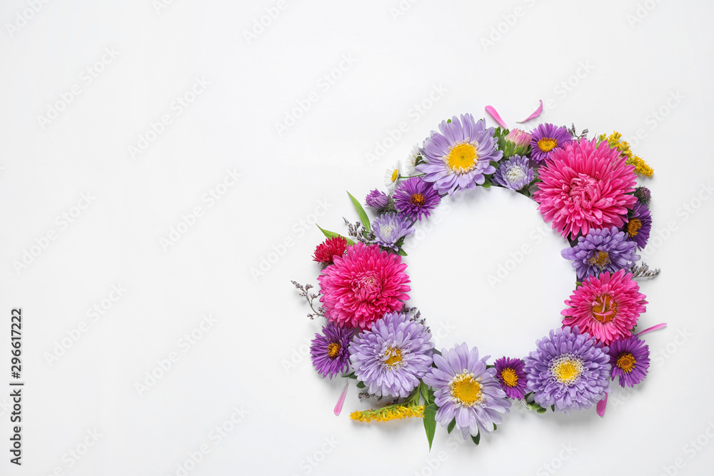 Composition with beautiful aster flowers and blank card on white background, top view. Space for text