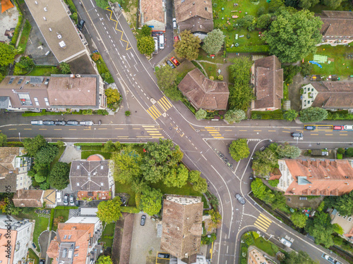 Aerial view of buildings with roofs. Streets with traffic in overhead view. Town in Europe from above..