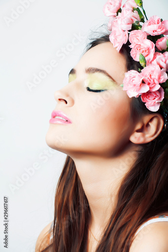 young pretty brunette woman with pink flowers and manicure posing cheerful isolated on white background closeup