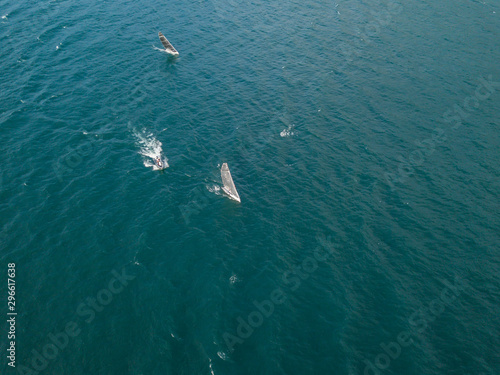 Aerial view of race sailboat on water cruising with high speed
