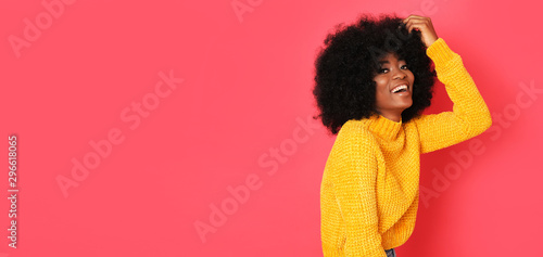 Laughing pretty afro girl in yellow sweater looks just precious.