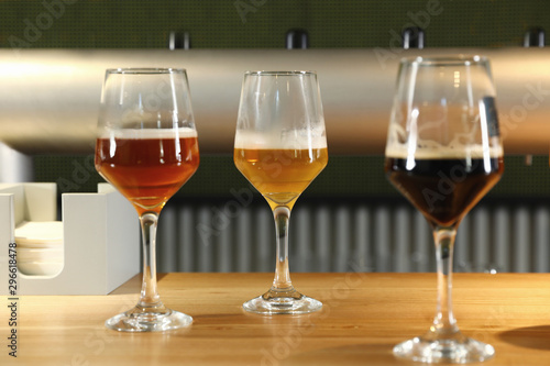 Different sorts of beer on wooden bar counter