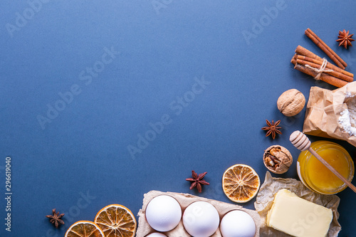 Traditional christmas holidays pastry ingredients and various kitchen utensils on paper textured background. Ginger cookies recipe concept. Close up, copy space, top view, flat lay.