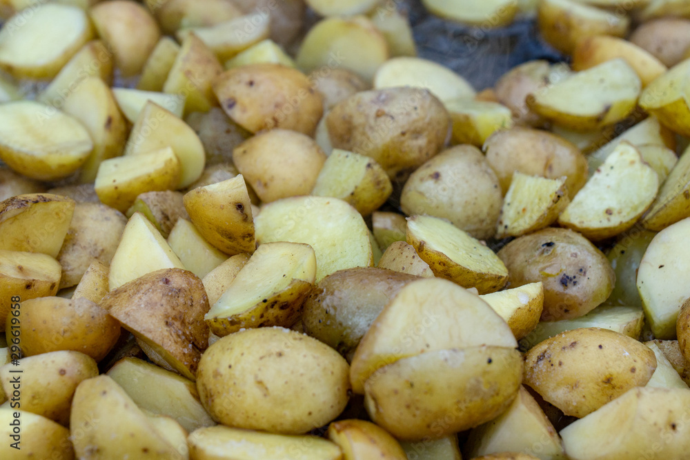 closeup homemade fried potato. Cooking fried potatoes in outdoor conditions on fire. Fire fried potatoes. Simple food. Potatoes in a black pan. closeup homemade fried potato. Cooking fried potatoes in outdoor conditions on fire. Fire fried potatoes. Simple food. Potatoes in a black pan.