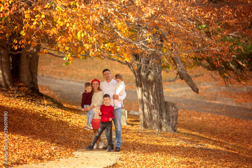 Happy family walks in the forest in autumn.
