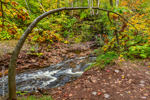 Fall color at rapids below the the middle waterfall of the Hungarian Falls in the Upper Peninsula of Michigan in the autumn. photo