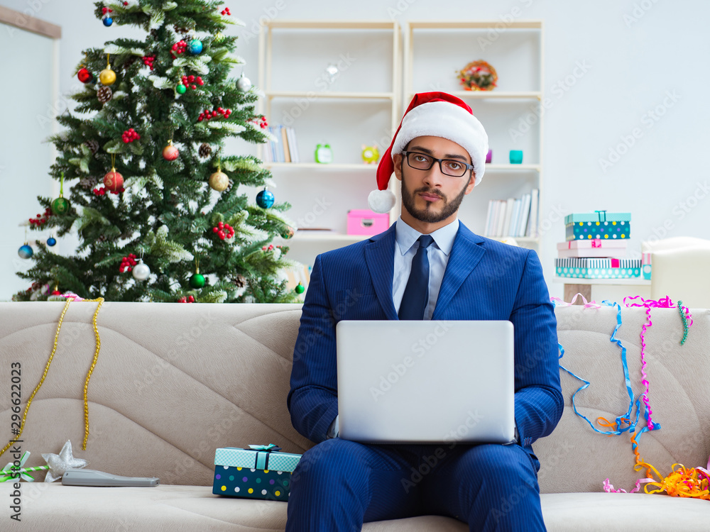 Businessman working at home during christmas Businessman working at home during christmas