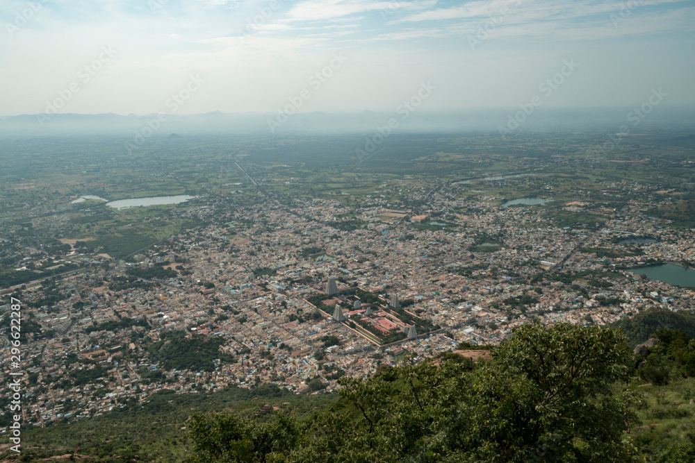 Overall view of the city of Tiruvannamalai and the Annamalaiyar temple from the Arunchalahill sacred mountain hiking on a summer day, Tiruvannamalai, Tamil Nadu, India 2019 Overall view of the city of Tiruvannamalai and the Annamalaiyar temple from the Arunchalahill sacred mountain hiking on a summer day, Tiruvannamalai, Tamil Nadu, India 2019